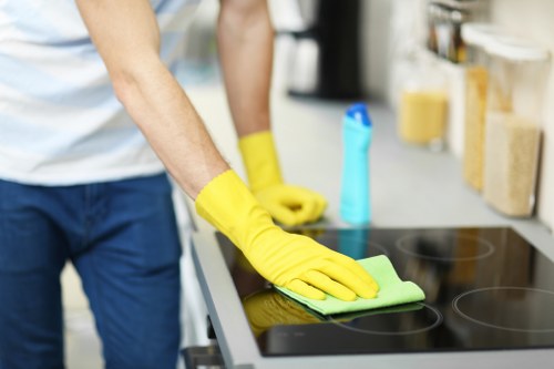 Carpet cleaning process in a Finsbury Park property with furniture nearby