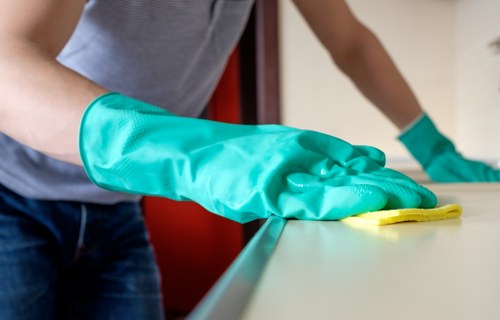 Local technician treating stains on a corner sofa in Finsbury Park